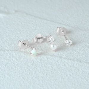 Detail of 925 sterling silver earring set with opal, pearl, and zircon gemstones