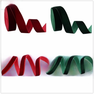 Detail of red and dark green velvet ribbons in 10mm and 25mm widths for DIY bows