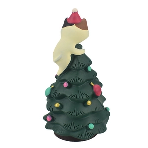 Close-up of resin green Christmas tree ornament with a cute kitten wearing a red hat