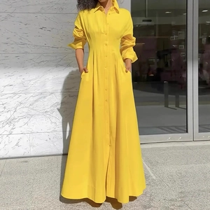 Close-up of vibrant yellow long-sleeved shirt dress with elegant button-down detailing