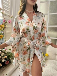 Détail d'un peignoir en satin à fleurs avec roses roses et ourlet à volants élégant
