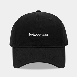 Close-up of the precise white embroidery on a classic black cotton twill baseball cap