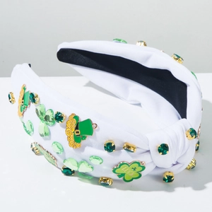 Detail of St. Patrick's Day headband with green crystals, clover charms, and Luck charm