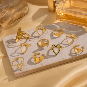 Set of 10 gold minimalist heart rings with green enamel and zircon stones on stone