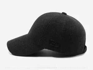Detail of grey wool baseball cap showing thick texture and side leather brand patch