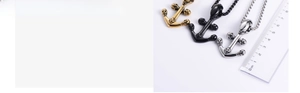 Macro detail of retro skull anchor pendant showing sizes with a ruler in three colors