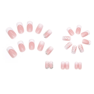 Pink and white gradient French press-on nails with 3D white flowers and sparkling rhinestones