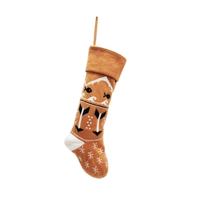 Detail of brown knitted Christmas stocking with white fish and snowflake patterns