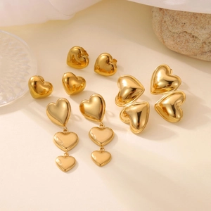 Detailed macro view of 18k gold heart earrings set with high polished mirror finish