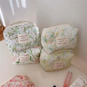 Quilted floral cotton cosmetic bags stacked with chic floral patterns and zipper closure