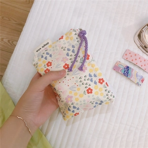 Detailed view of floral cotton mini pouch with zipper and simple wish label