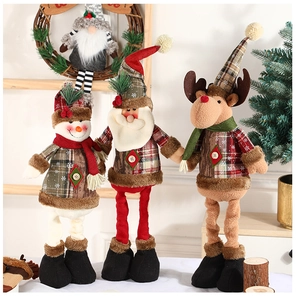 Three plush Christmas figurines with retractable legs in festive red and green plaid outfits