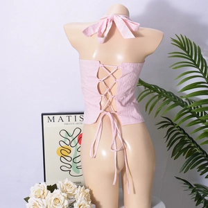 Dettaglio del top rosa con allacciatura al collo e design incrociato sulla schiena