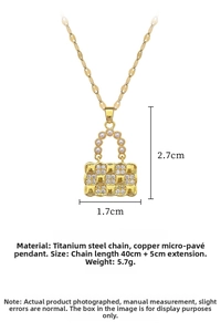 Detailed view of gold handbag pendant with pearls and micro-pave crystals on titanium chain