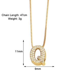Detail shot of a gold-plated necklace with a zircon-inlaid letter Q pendant