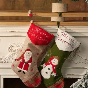 Classic Christmas stockings set with Santa and Snowman embroidery hanging on fireplace
