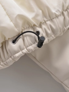 Detail of off-white jacket showing faux leather texture and black drawstring toggles