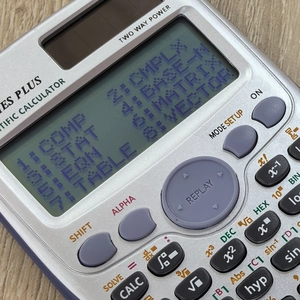 Detail of 991ES PLUS scientific calculator LCD screen showing functional calculation modes