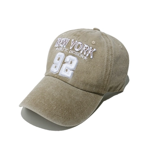 Macro view of khaki cotton baseball cap with white 3D New York athletic embroidery