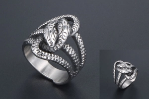 Detailed view of the double snake head design on a punk style silver titanium steel ring
