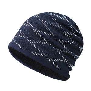 Detailed close-up of navy blue winter knit beanie with sparkling rhinestone patterns and lining