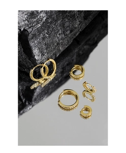 Macro detail of various sizes of gold plated S925 silver hoop earrings with zircon