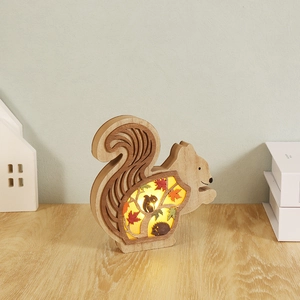 Luminous carved wooden squirrel figurine with interior LED lighting and autumn theme