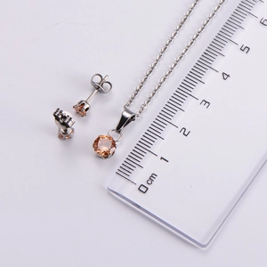 Detail of champagne zircon jewelry set showing pendant and earring dimensions with ruler