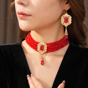 Vintage style choker set with four-strand red beads and ornate gold floral pendant