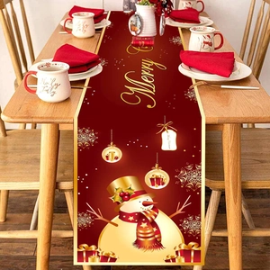 Red Christmas table runner with golden snowman and Merry Christmas print for dining decor