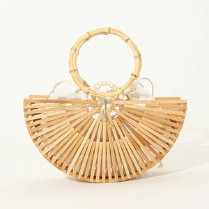 Detail of handmade semi-circular bamboo handbag with round handle and canvas drawstring bag