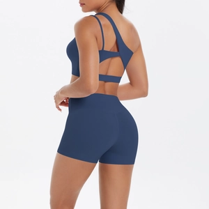 Detail showing asymmetric back cutout design and high waist shorts in navy blue knit