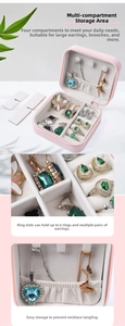 Detailed internal compartments of pink PU leather jewelry box showing ring slots and hooks