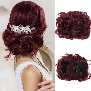 Close-up of wine red curly hair bun piece with comb clip and floral hair accessory