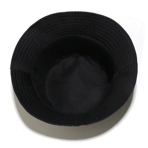 Detail view of the black cotton bucket hat showing interior lining and reinforced stitching