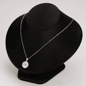 Minimalist silver stainless steel necklace with engraved Hope pendant on display stand