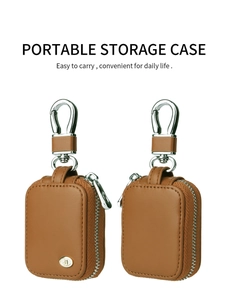 Detailed view of two brown leather case covers for AirPods 3 with metal hooks and zippers