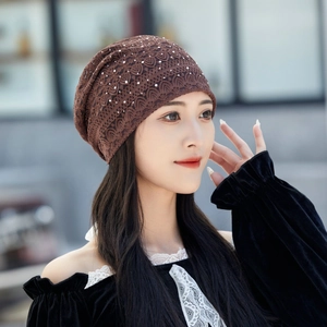 Close-up of dark brown lace slouchy beanie featuring elegant white pearl bead detailing