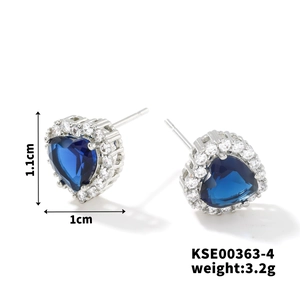 Detail view of heart-shaped blue zircon stud earrings with sparkling white halo
