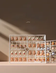 Detailed view of resin 3D bear and bunny nail art charms on a grid stand