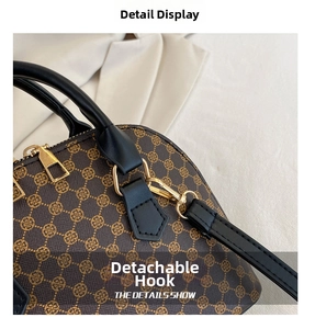 Macro detail of retro patterned handbag with golden hardware and detachable strap hook