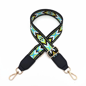 Detail of adjustable bohemian geometric pattern bag strap with gold lobster clasps