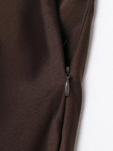 Detail of dark brown satin skirt featuring a high-quality seamless invisible zipper