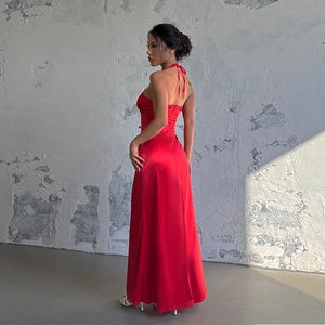 Detail of red backless satin maxi dress showing halter neck and sleek silhouette