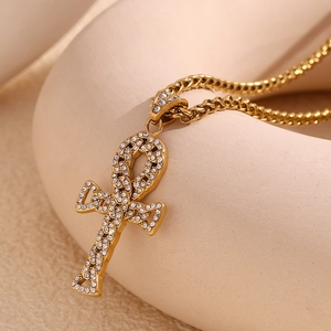 Macro shot of 18K gold plated Ankh cross pendant with sparkling zircon micro-pave details