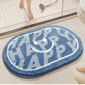 Close-up of oval blue bathroom mat with Happy pattern and water absorbent plush texture