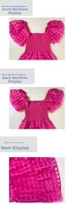 Detail view of pink plaid smocked dress with off-shoulder puff sleeves and textures