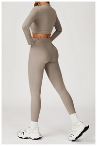Detail of high-waist yoga leggings and long sleeve crop top in taupe ribbed knit fabric
