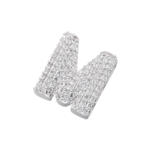 Close-up of silver pendant letter M with micro-paved sparkling cubic zirconia stones