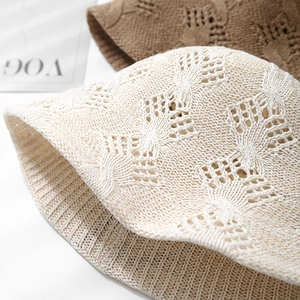 Detailed close-up of textured hollow-out crochet knit patterns on stylish bucket hats